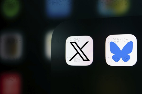 A close up of an iPhone screen displaying the X (twitter) app icon and the Bluesky app icon.