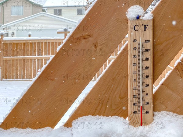 A Thermometer on a snow fall with a cold temperature