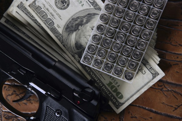 Dollar notes and gun, black pistol, mafia inspiration