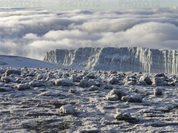 glacier remains and snow covered summit of Mount Kilimanjaro in Tanzania just after sunrise