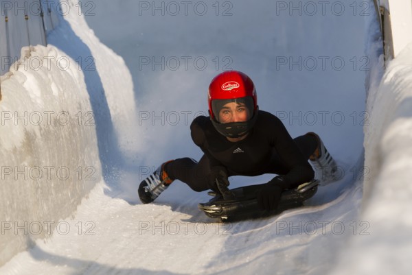 Person riding a skeleton sled at the Innsbruck bobsleigh track, Igls Olympic Bobsled Run, Igls,