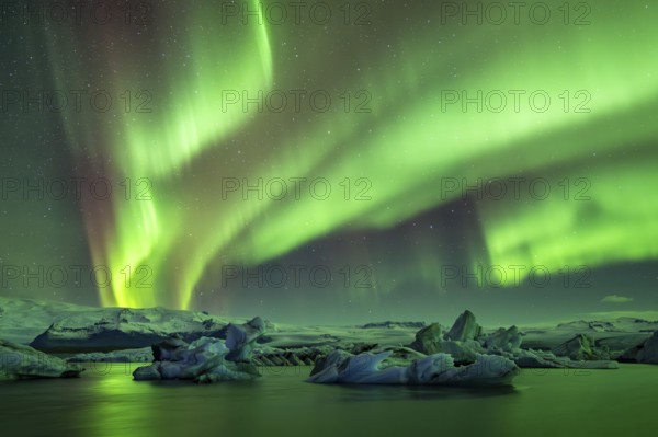 Northern Lights over icebergs in the glacier lagoon, Jökulsarlon, icebergs with glacier,