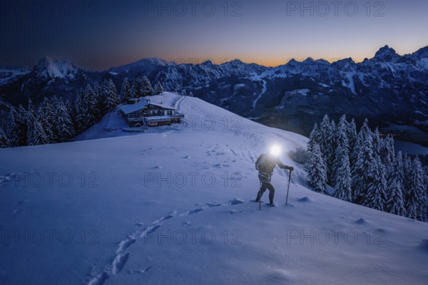 Hiking in the snow in the snow-covered winder landscape in the Alps at Neunerköpfle in the