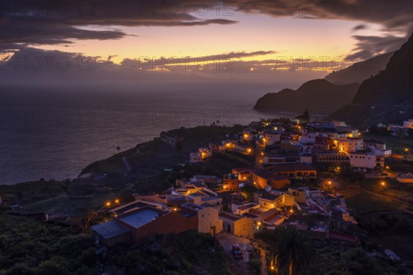 The village of Agulo shortly in front of sunrise. Houses and streets are still illuminated. View of