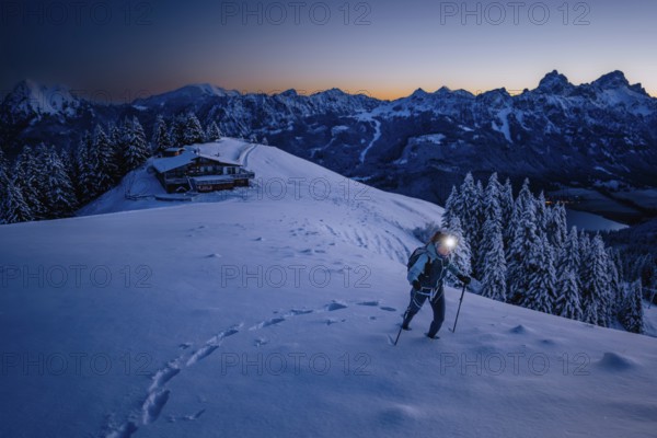 Hiking in the snow in the snow-covered winder landscape in the Alps at Neunerköpfle in the