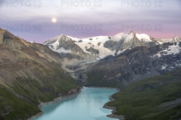 Mountain landscape with turquoise blue reservoir Lac des Dix and summit Mont Blanc de Cheilon, moon