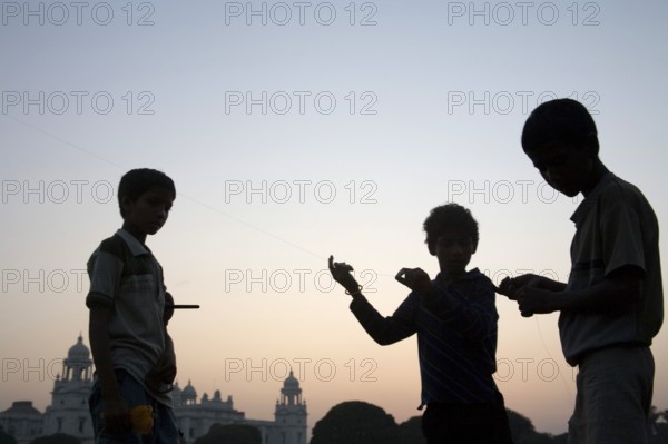 Children flying kite near at Victoria memorial impressive reminder of British Raj built between