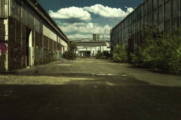 Abandoned industrial site with graffiti under a cloudy sky, Gerresheimer Germany, Lost Place,
