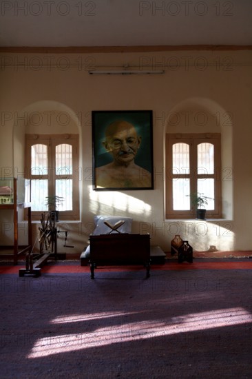 Mahatma Gandhi sitting place with his large photograph and his charkha at Satyagraha Ashram founded