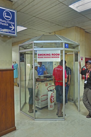 Smoking room with smoking locals, airport, Denpasar, Bali, Indonesia, Asia