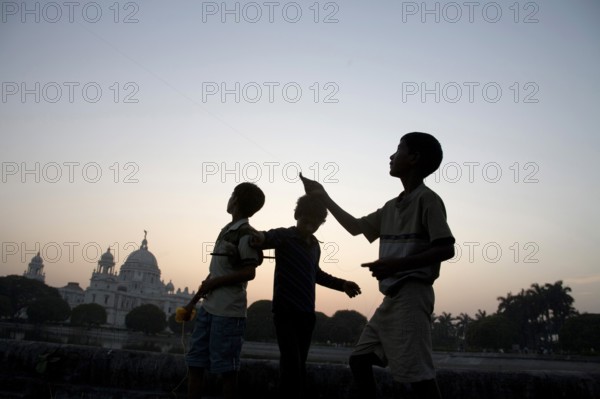 Children flying kite near at Victoria memorial impressive reminder of British Raj built between