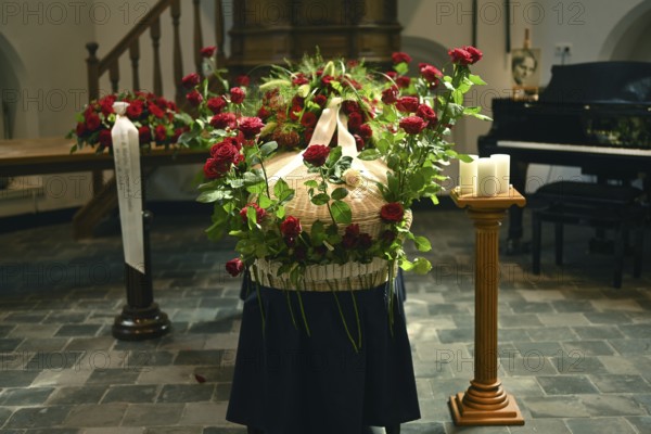 Red rose at the coffin, farewell to a dear deceased in the church in the Dutch province of Drenthe,