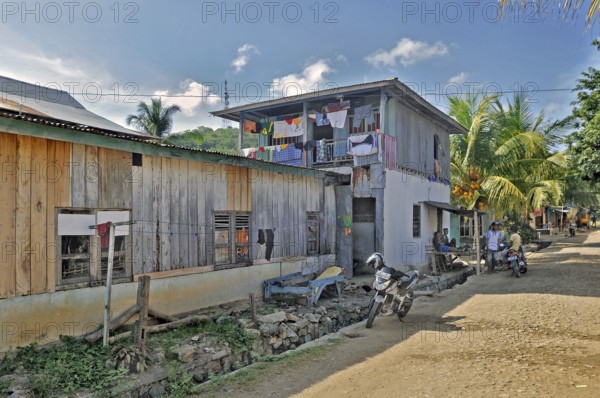 Side street with colourful laundry and locals in Labuan Bajo, Flores Island, Indonesia, Asia