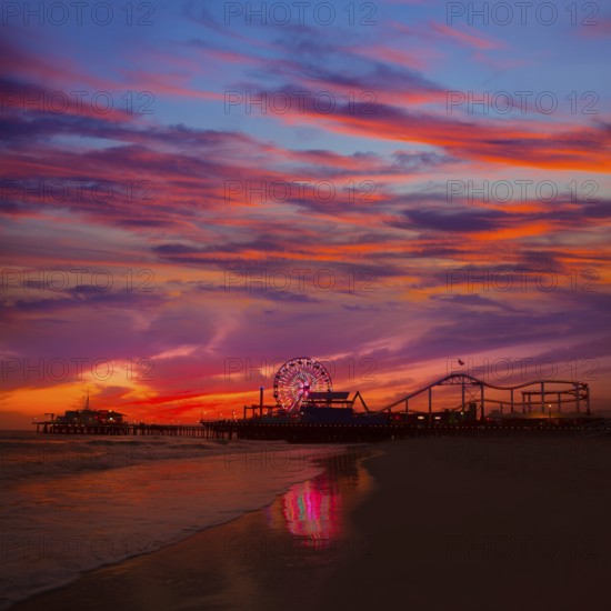 Santa Monica California sunset on Pier Ferrys wheel and reflection on beach wet sand