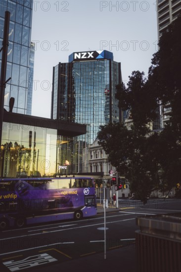 Modern glass building labelled NZX, surrounded by urban environment, new zealand stock exchange,