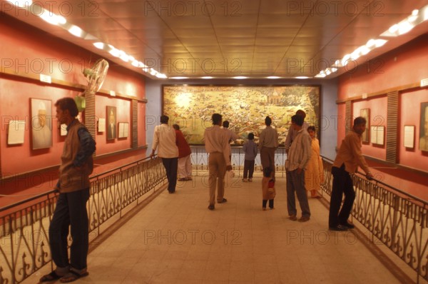 Visitors at the Jallianwala Bagh memorial in Amritsar in Punjab, India have a look at the huge