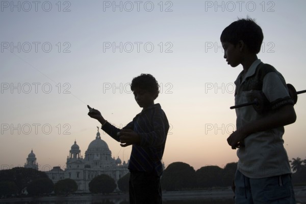 Children flying kite near at Victoria memorial impressive reminder of British Raj built between