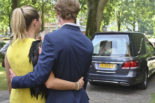 Children relatives and friends say goodbye to a deceased loved one, hearse, Dutch province of