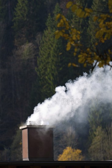 Smoking chimney of a residential building. Exhaust fumes and environmental protection Austria
