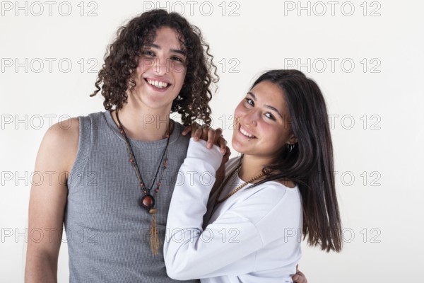 Portrait of a young couple dressed in yoga clothes looking ti the camera white background. Studio