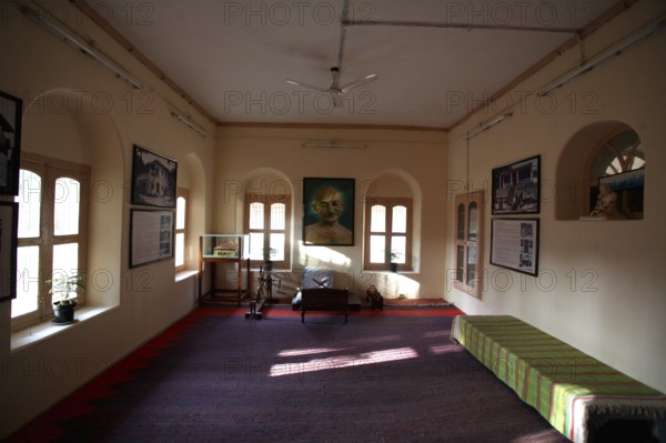Mahatma Gandhi sitting place with large photograph and charkha at Satyagraha Ashram founded in