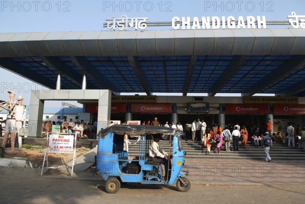 Blue auto rickshaw stand in front of Chandigarh railway station built in 1954, India Union