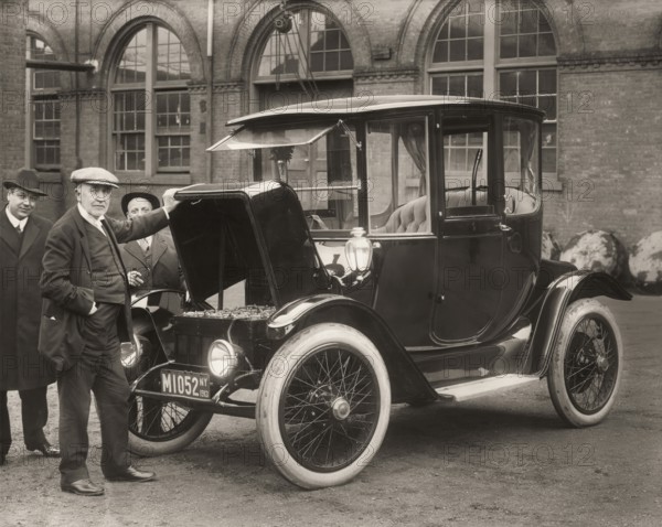 Thomas Alva Edison displaying storage batteries of the power Detroit Electric automobile, 1913,