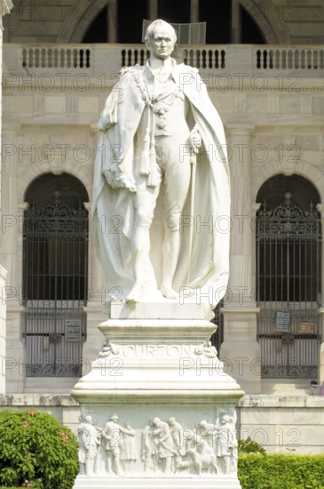 Statue of Lord Curzon stands in front of his creation of Victoria Memorial monument built between