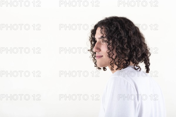 Portrait of a young man dressed in white yoga clothes over white background. Studio shot. Copy