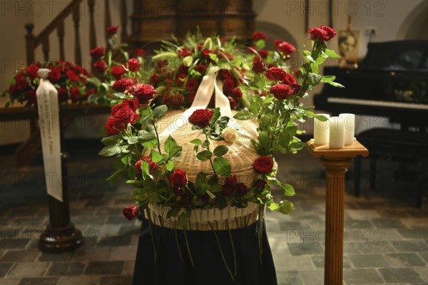 Red rose at the coffin, farewell to a dear deceased in the church in the Dutch province of Drenthe,