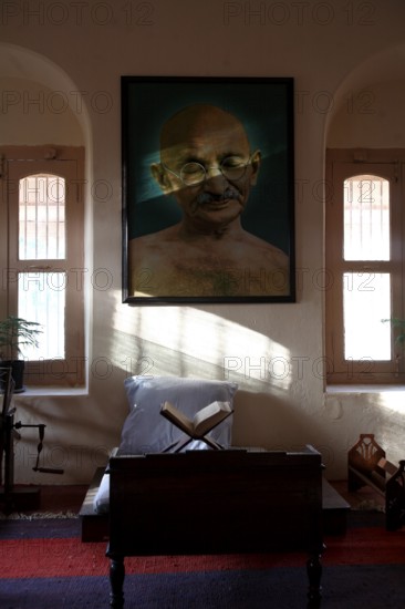 Mahatma Gandhi sitting place with his large photograph and his charkha at Satyagraha Ashram founded