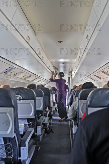 Flight attendant, obsolete stewardess, propeller aircraft, jet-prop Fokker 50, former Riau