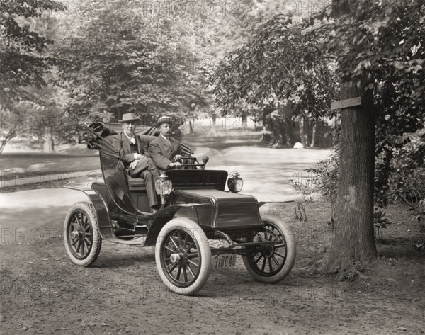 Thomas Alva Edison and William Billy Bee in Detroit Electric automobile on Edge Hill Avenue in