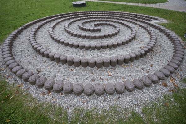 Built snail made of stones in front of the fortress walls of Dinkelsbühl, Bavaria, Germany, Europe