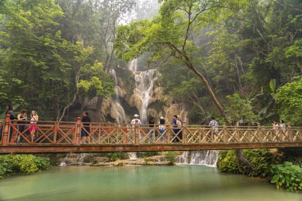 Tourists on the bridge at Kuang Si waterfall near Luang Prabang, Laos, Asia