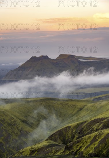 Fog between mountains, moss-covered volcanic mountain landscape, at sunset, Pakgil, Iceland, Europe