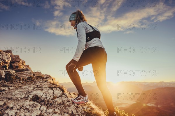 Trail running in autumn on the Jochberg on Lake Walchensee against the wonderful backdrop of the