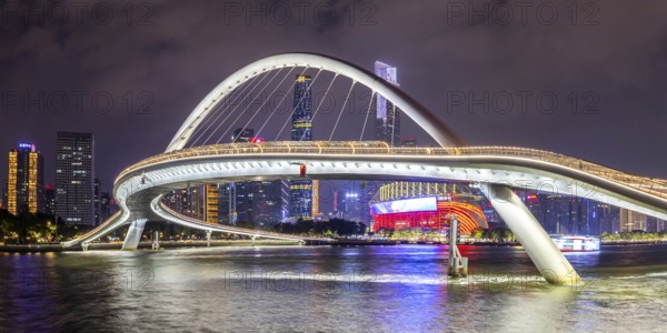 Guangzhou skyline with Haixin Bridge across the Pearl River skyscrapers panorama at night in