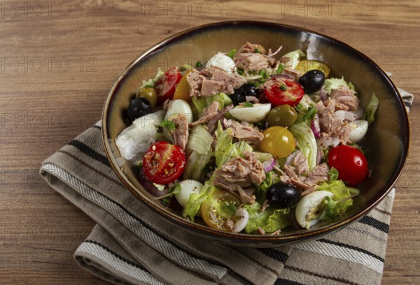 Salad with canned tuna, vegetable salad with quail eggs, lettuce, red onion, cherry tomatoes,