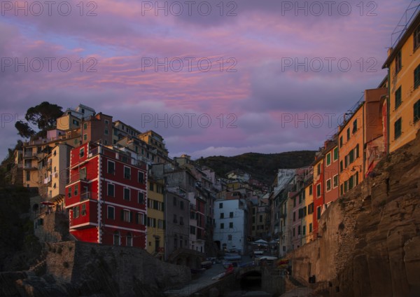 Italy, Riomaggiore colorful buildings overlooking scenic shoreline. Cinque Terre landscapes in