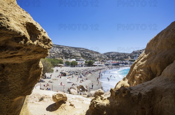 View from the rock caves to the beach of Matala, south coast, Crete, Greece, Europe