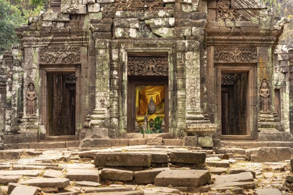 Modern Buddha statues in the central sanctuary of the mountain temple Wat Phu, Champasak province,
