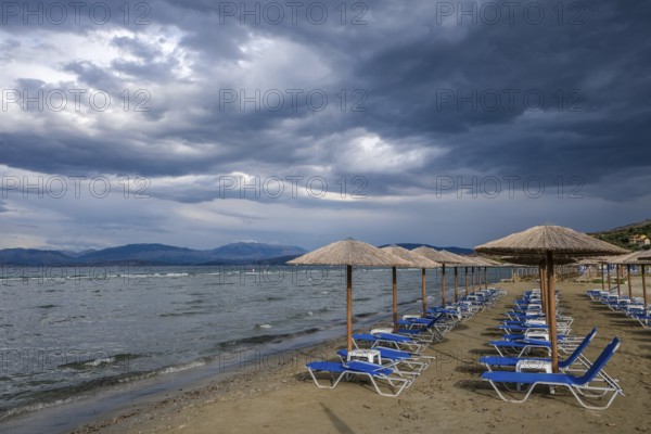 Kalamaki, Corfu, Greece, Sun loungers and parasols on Kalamaki beach in the north-east of the Greek