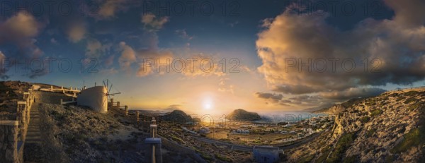 Picturesque sunset over a Mediterranean coastal landscape of Arkasa with windmill and sea view,