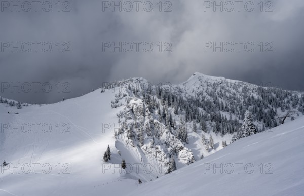 Mountain landscape in the snow, mountain peaks Tanzeck and Aiplspitz, dramatic clouds,