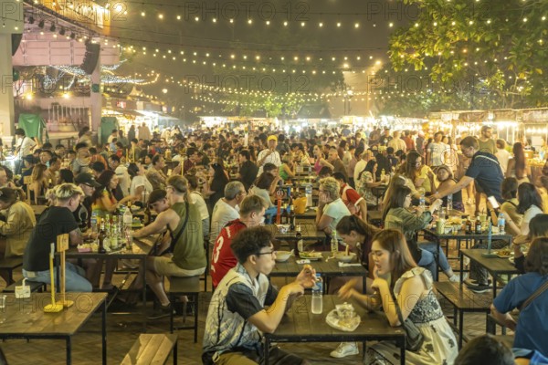 Crowded dining tables at the night market in Luang Prabang, Laos, Asia
