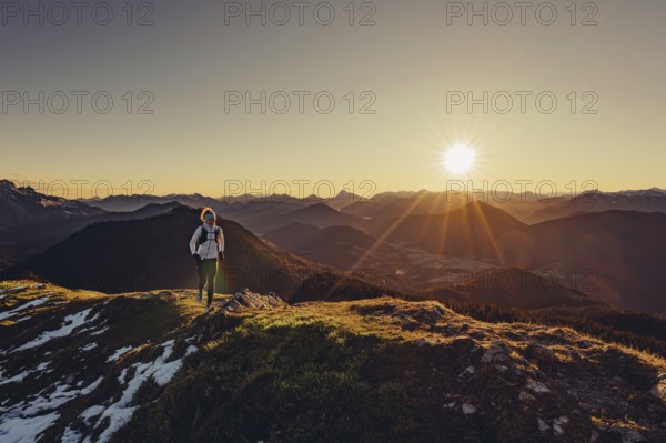 Trail running in autumn on the Jochberg on Lake Walchensee against the wonderful backdrop of the