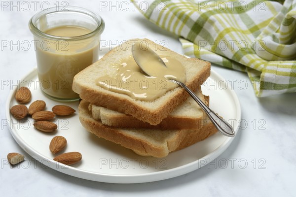 Almond cream on toast, almonds and spoon