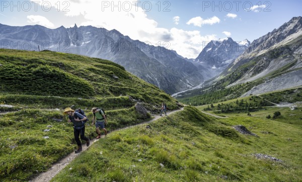 Mountaineer on a hiking trail, mountain landscape near Arolla, behind mountain peak Mont Collon,