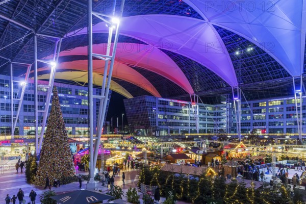 Christmas market at the airport in the evening, market stalls decorated for Christmas in front of